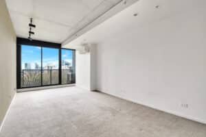 Empty room with sliding glass doors to a balcony